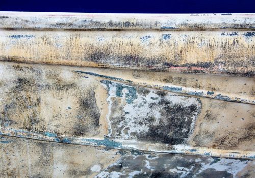Close-up of an old boat's decaying surface with rustic textures, perfect for background use.
